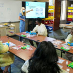 A group of students participate in a preview of college life in a health sciences class