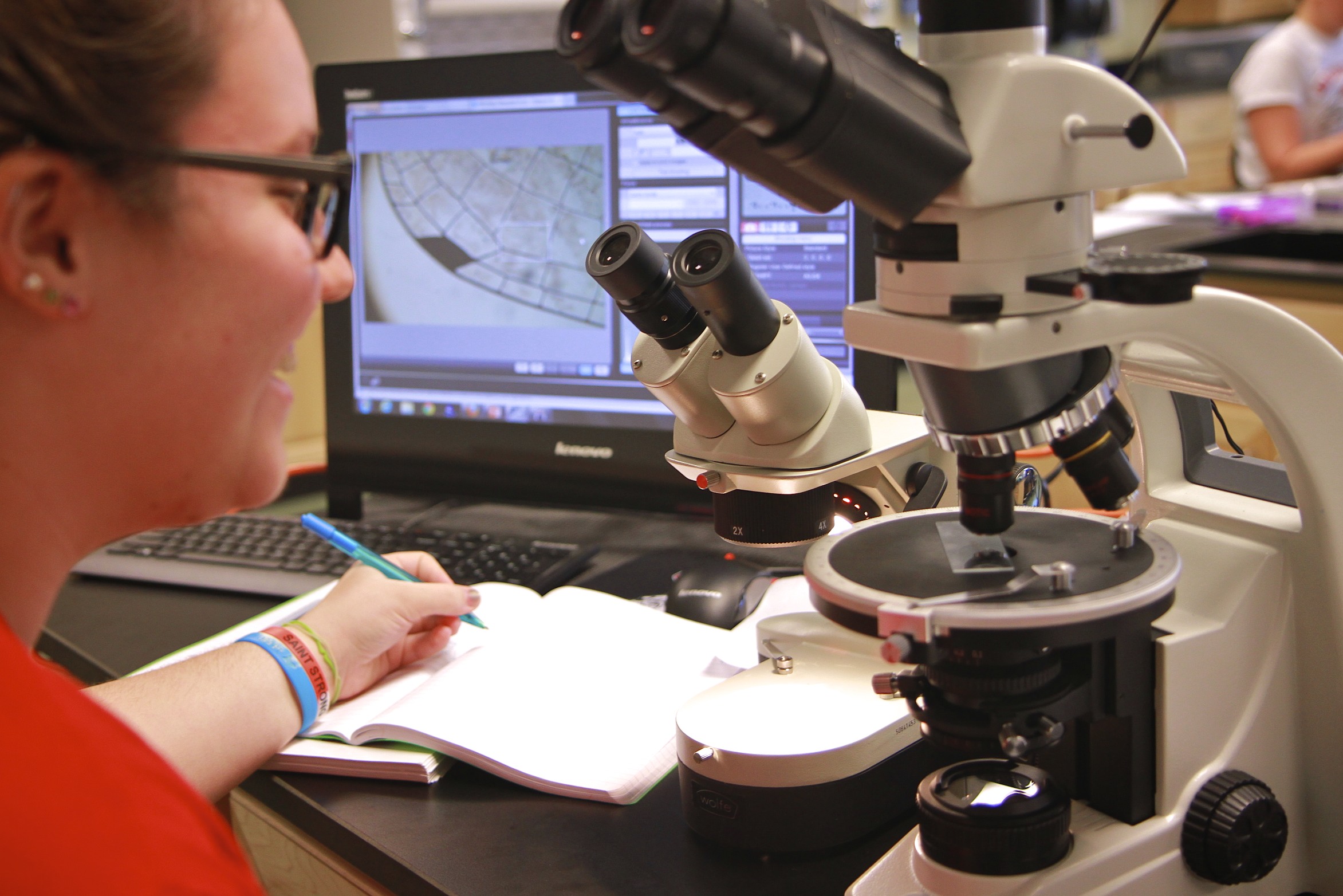 natural sciences student using a microscope