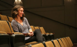 Amber McGinnis sitting in theater directing