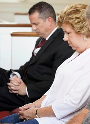 Dr. Downs and wife praying