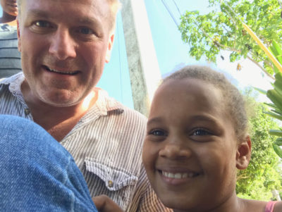 Jack Eason with child from mission