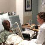 Kelsey Nehriq with patient in hospital