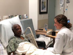 Kelsey Nehriq with patient in hospital