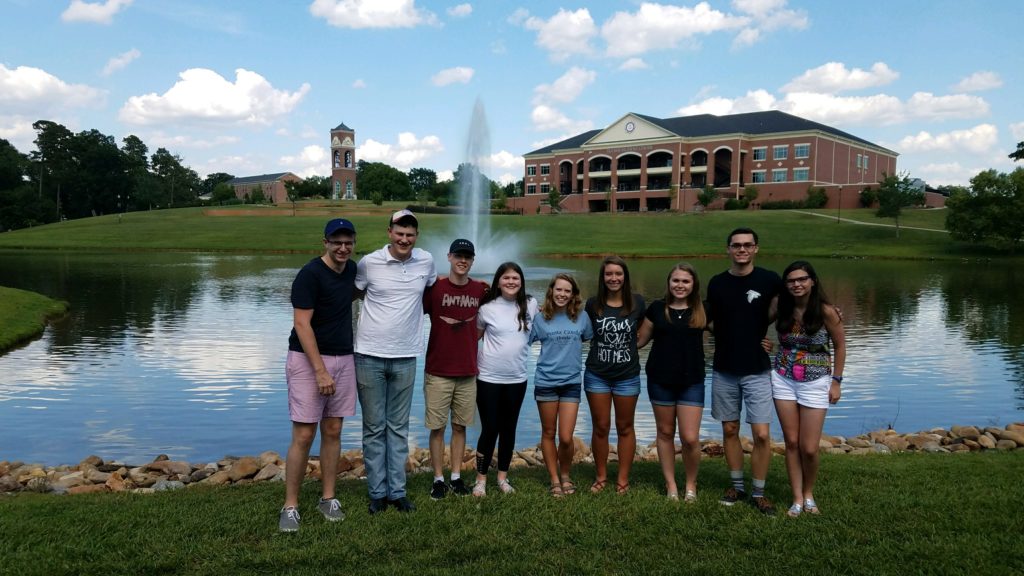 group of students in front of lake