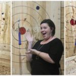 A photo collage featuring three photos of women who are pointing and smiling to the axe they threw at Lumber Jill's and hit the target