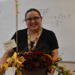 GWU Alumna Chasity McCraw receives flowers for being honored Teacher of the Year