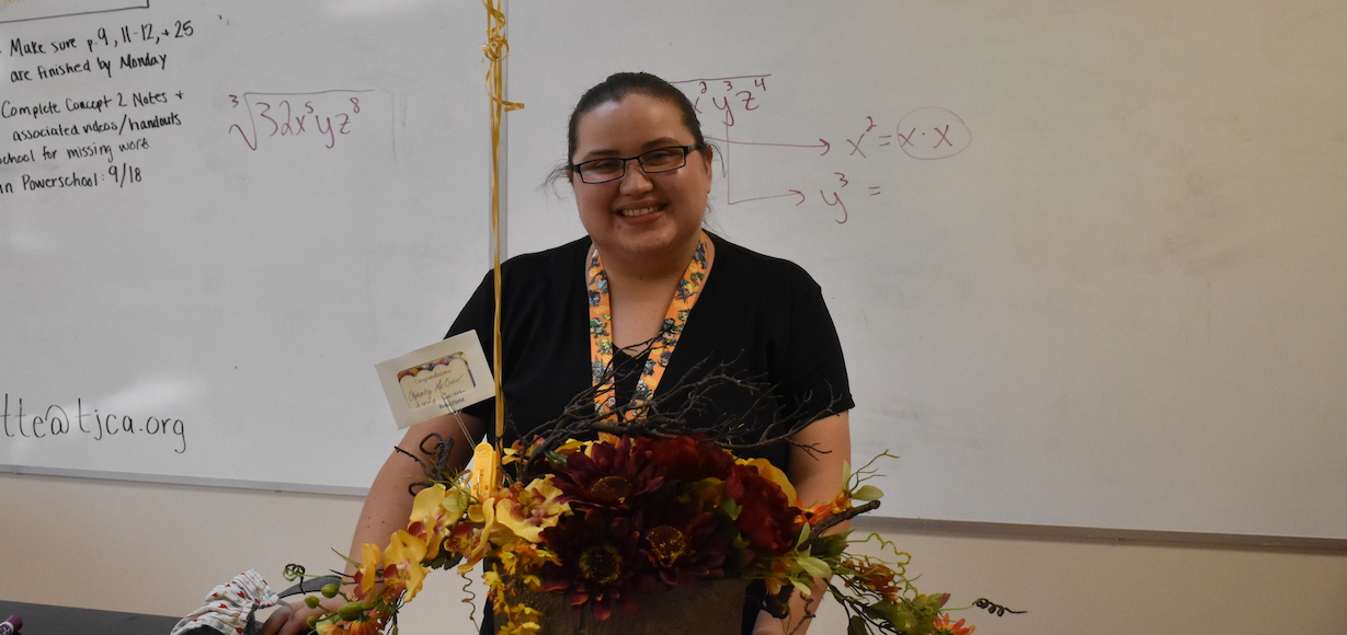 GWU Alumna Chasity McCraw receives flowers for being honored Teacher of the Year