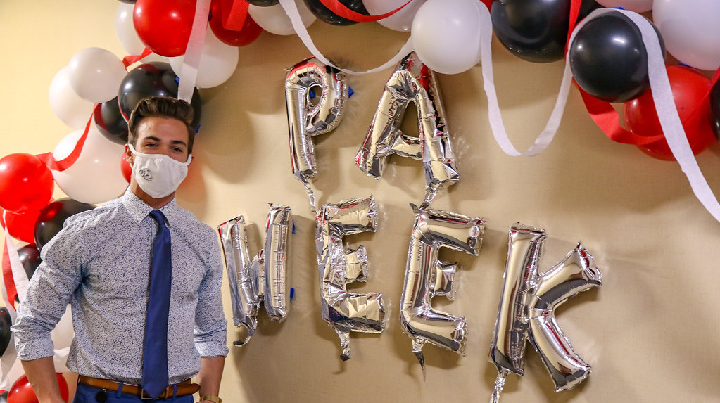 A photo of Ethan Garris in front of PA Week balloons