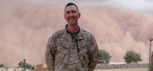 GWU Alumnus Terry Eddinger poses during a sand storm in Iraq when he served with the Marines.