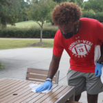 student cleaning table