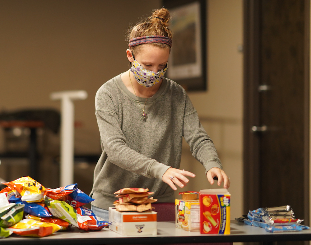 A Gardner-Webb Student sorts snack food that will be placed in backpacks and given to children in need