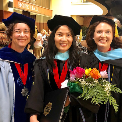 Thanh-Thuy T. Nguyen, center, poses with Dr. Sydney Brown, left, and Dr. Jennifer Putnam on her graduation day.