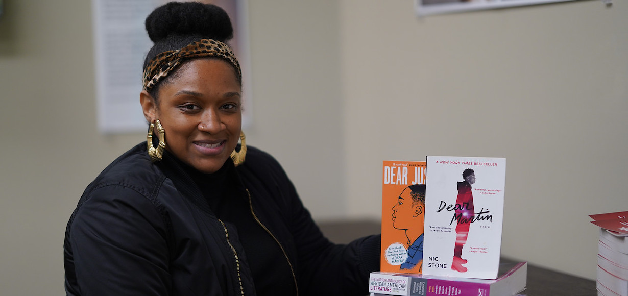 Dr. Kemeshia Swanson poses with some of the books she will be using in her African American Literature Course.