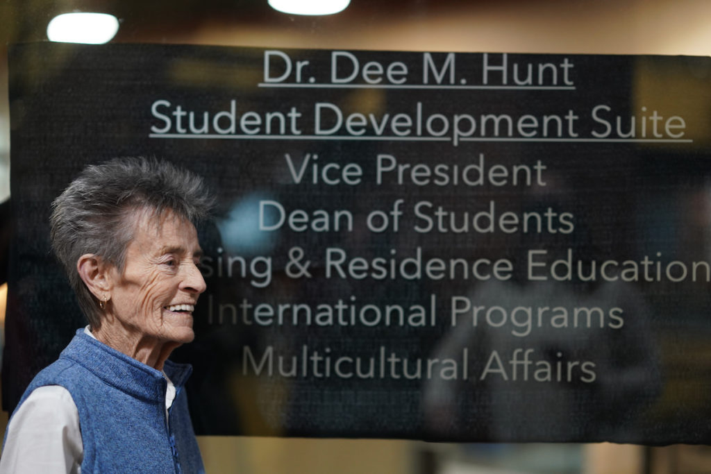 Dr. Dee Hunt stands in front of the Student Development Suite recently named in her honor