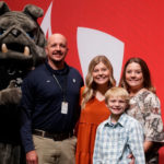 From left, Lisa Tucker, representing the Tucker family, Mascot, Mack the Bulldog, Kyndal’s parents, Josh and Shannon Jackson, her brother, Wyatt; Kyndal Jackson; and GWU President Dr. William M. Downs..