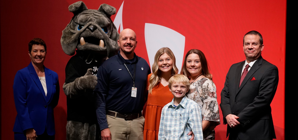 From left, Lisa Tucker, representing the Tucker family, Mascot, Mack the Bulldog, Kyndal’s parents, Josh and Shannon Jackson, her brother, Wyatt; Kyndal Jackson; and GWU President Dr. William M. Downs..