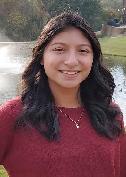 Karley Chavez Callejas on campus in front of lake