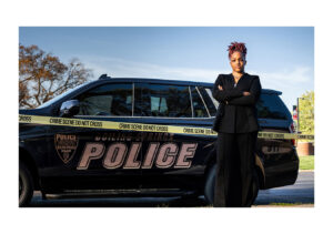 GW student micahla funderburk standing in front of crime scene tape and police vehicle