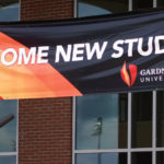 A welcome new students banner hangs at the entrance of Tucker Student Center