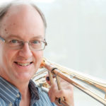 a photo of John Ilika holding a trombone