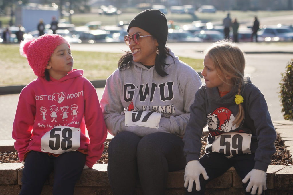 A woman and two girls wait for the 5K to begin.