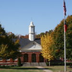 a photo of Craig Hall with the flag pole in front