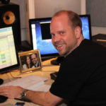 Peter Myles sits at his computer