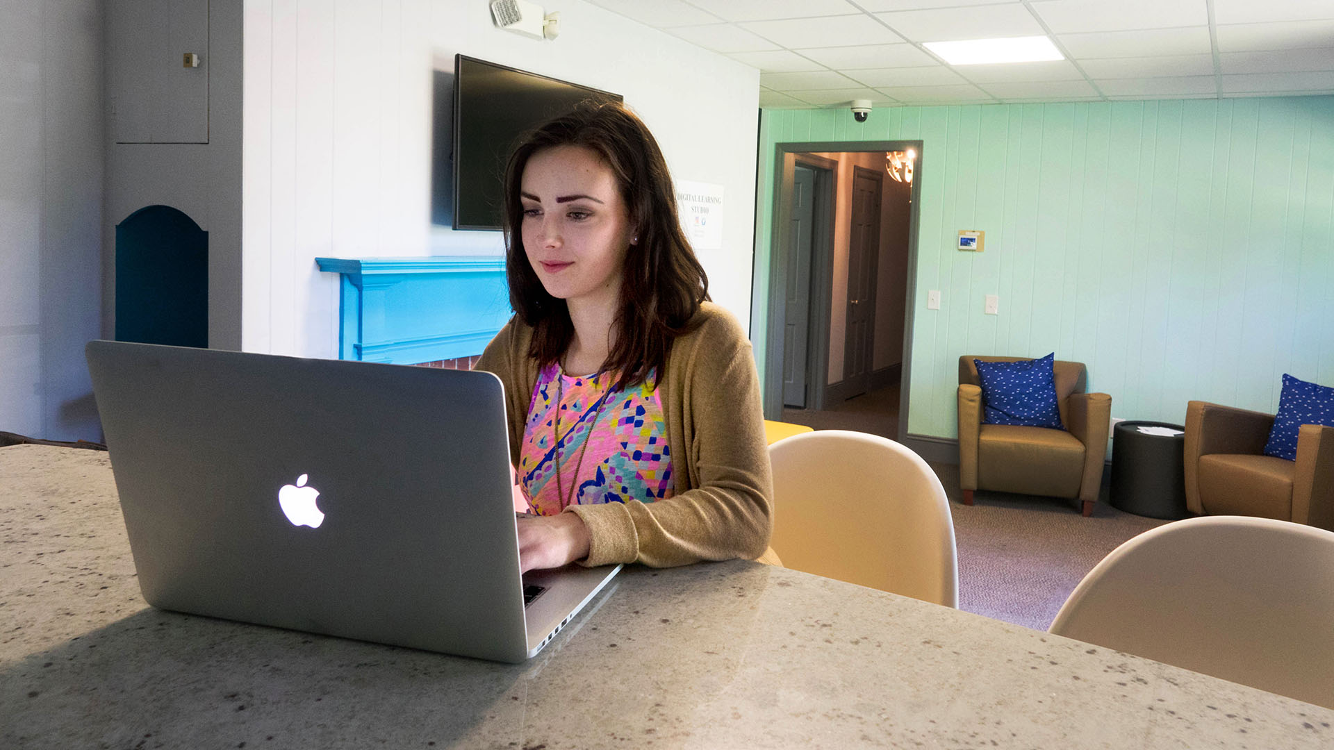 Student in digital lab using laptop