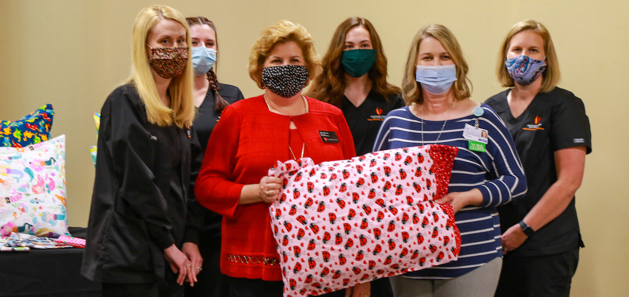 Kim Downs, third from left, poses with nursing students and Dr. Nicole Waters and Dr. Tracy Arnold before giving the pillowcases to the hospital.