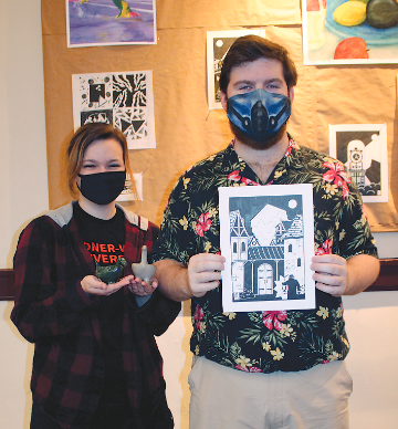 GWU Art Students, Chris Dover and Shaila Hart, hold their artwork.
