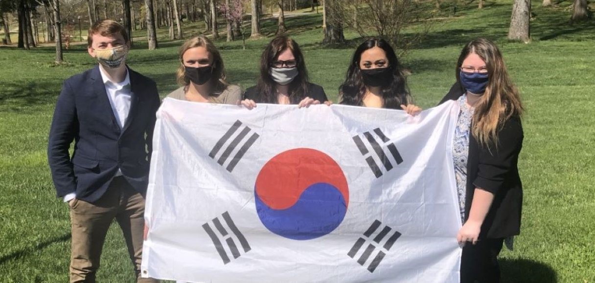 GWU's Model UN Team holds the flag of the Republic of Korea