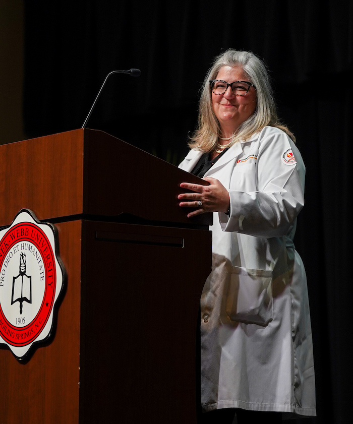 Dr. Ami R. Steele, associate professor, department chair and program director of PA Studies, welcomes the group to the white coat ceremony.