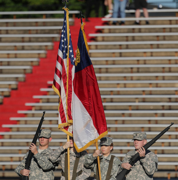 The ROTC Color Guard Presents the American and N.C. flags. 