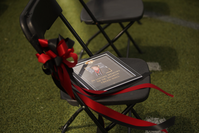 A chair holds a memorial tribute for Dr. Sharon Creed Hall.