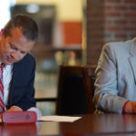 GWU President Dr. William M. Downs, left, and RichmondCC Vice President for Instruction Kevin Parsons sign the articulation agreement between the two institutions .