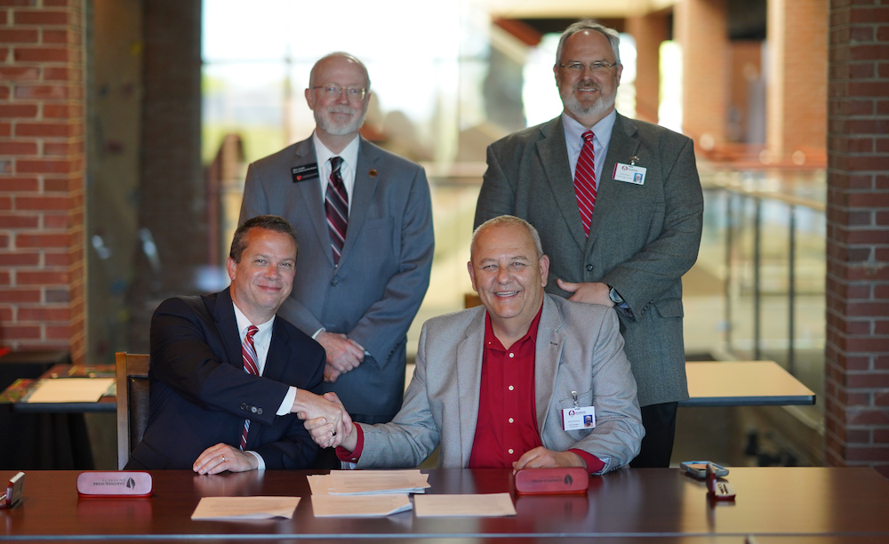 The four representatives of Gardner-Webb and Richmond Community College. Seated are GWU President Dr. William Downs, left, and RichmondCC Vice President for Instruction, Kevin Parsons. Standing are, Provost and Executive Vice President Dr. Ben Leslie, left, and RichmondCC Executive Vice President/CFO Brent Barbee.