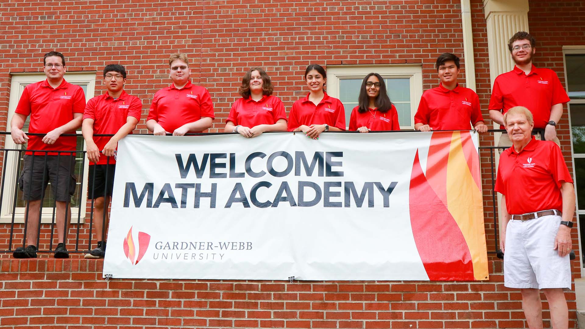 Students holding a Welcome Math Academy Banner
