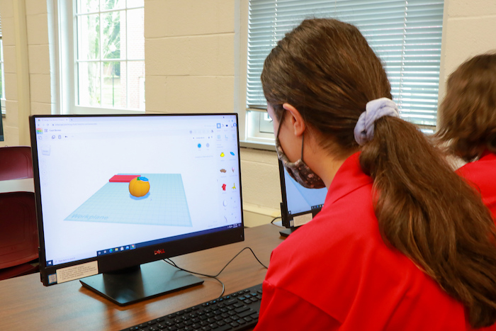 A student in the math academy creates an object to print on the 3D printer.