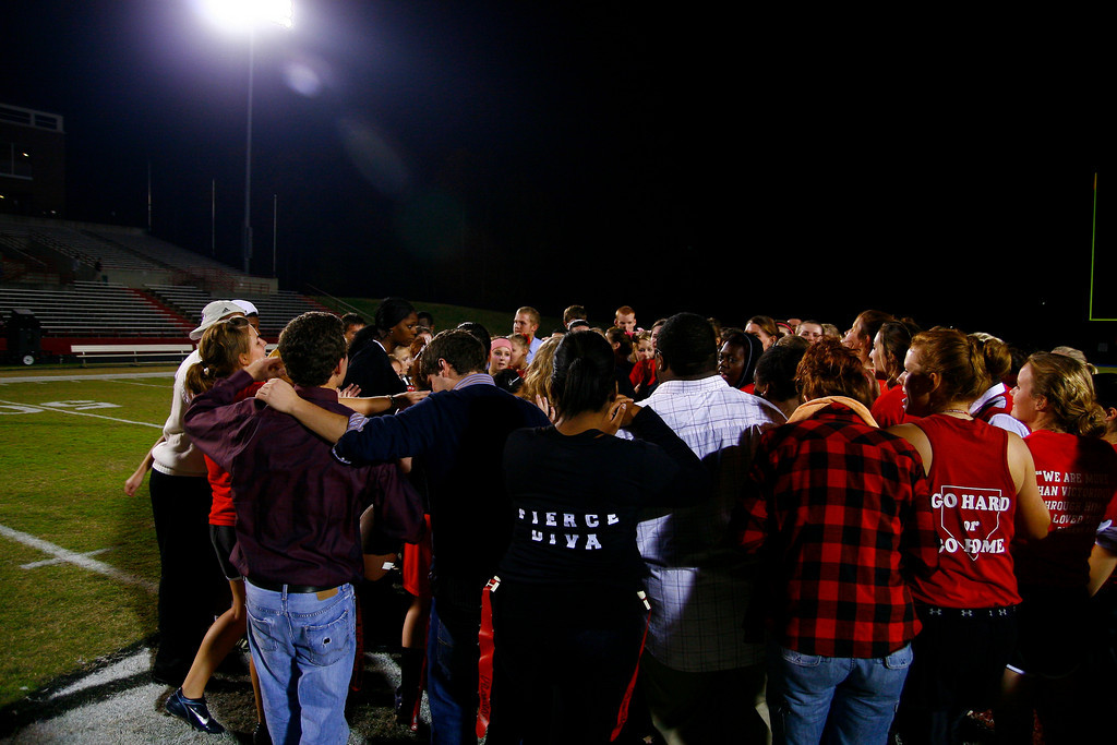 Groups of students praying before football game