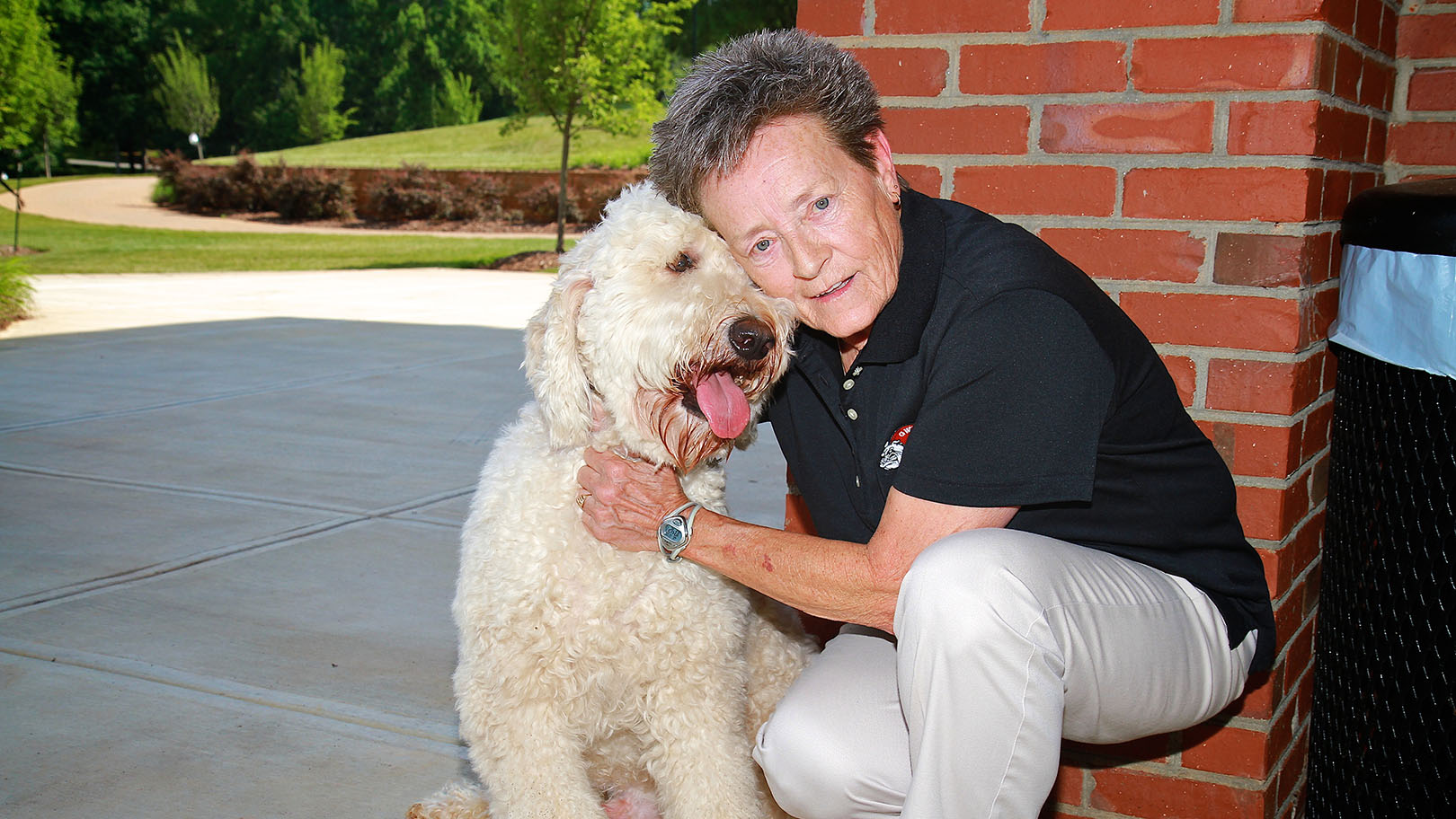 Dr. Dee Hunt on campus with dog in 2013
