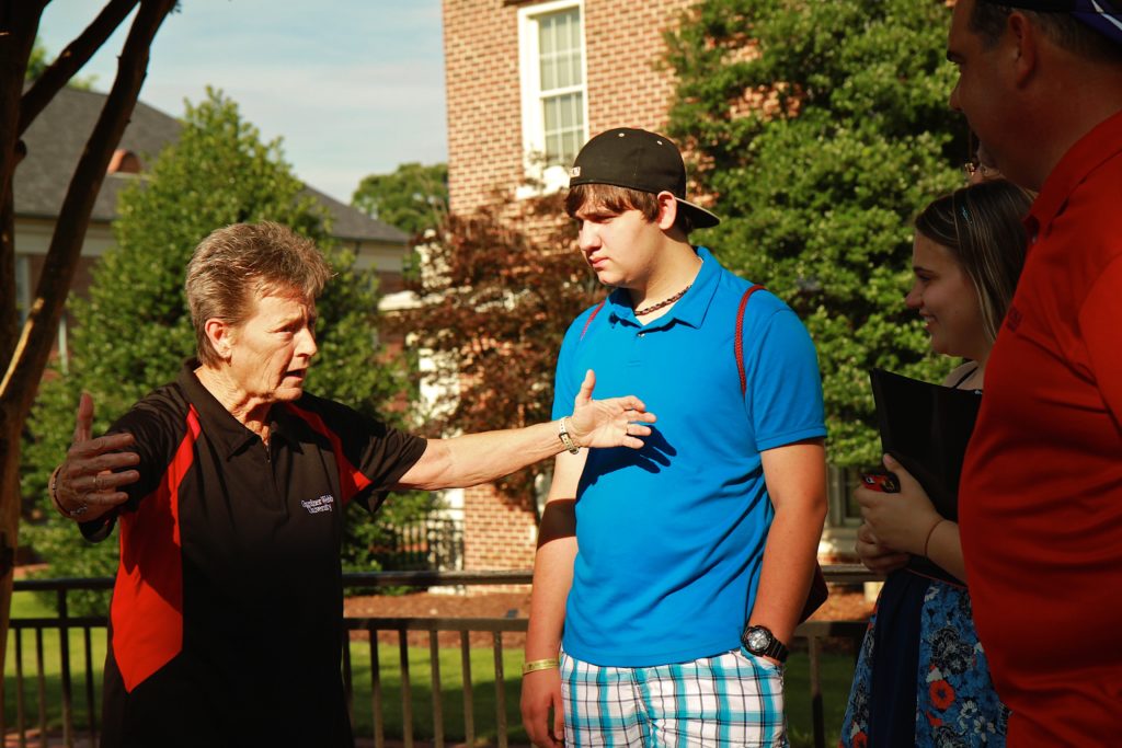 Dr. Dee Hunt with students on GWU campus
