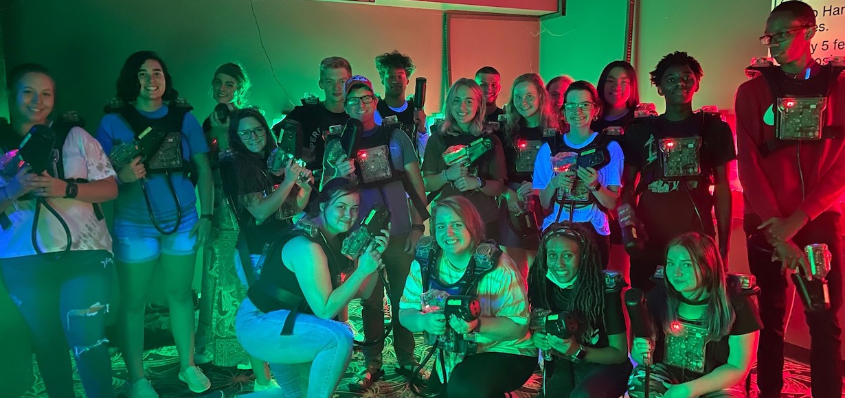 Students pose as a group after playing laser tag.
