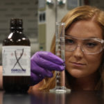 Cailen Blaire looks at a test tube in the lab at GWU.
