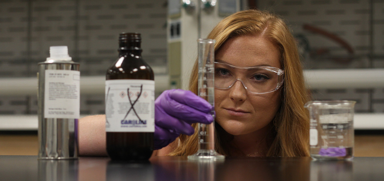 Cailen Blaire looks at a test tube in the lab at GWU.