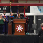 Six people on the stage at the Fall Convocation