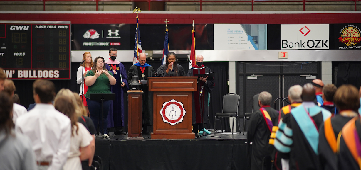 Six people on the stage at the Fall Convocation