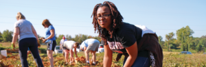 GWU student working in garden on mission trip