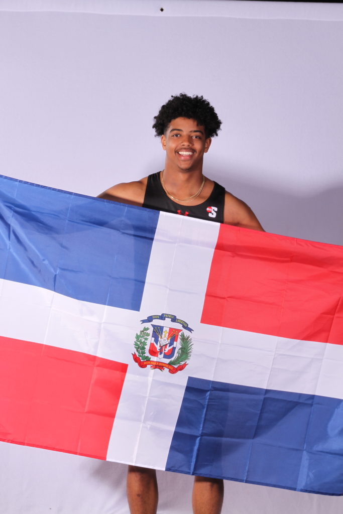 Eliel Cuesta holds the flag of the Dominican Republic.