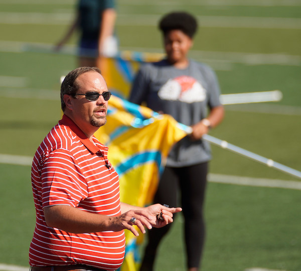 Interim band director, Michael Henderson directs practice on the football field.