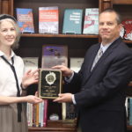 Dr. Abby Garlock receives the award from Dr. William Downs